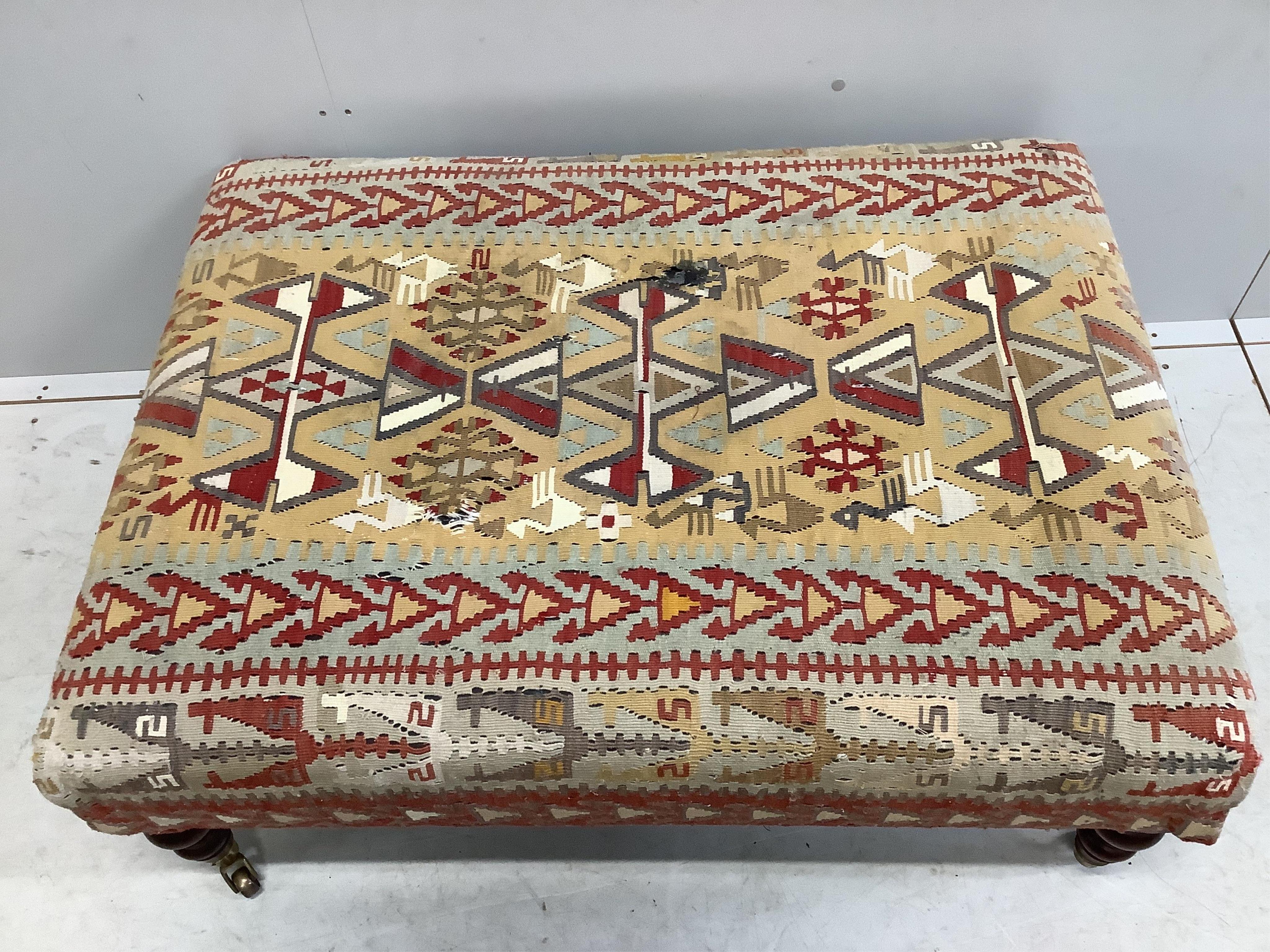 A rectangular Victorian style footstool with Kilim upholstery, width 102cm, depth 76cm, height 41cm. Condition - poor to fair